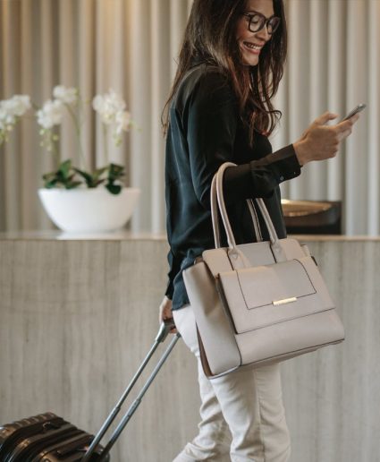 woman with luggage checking into hotel