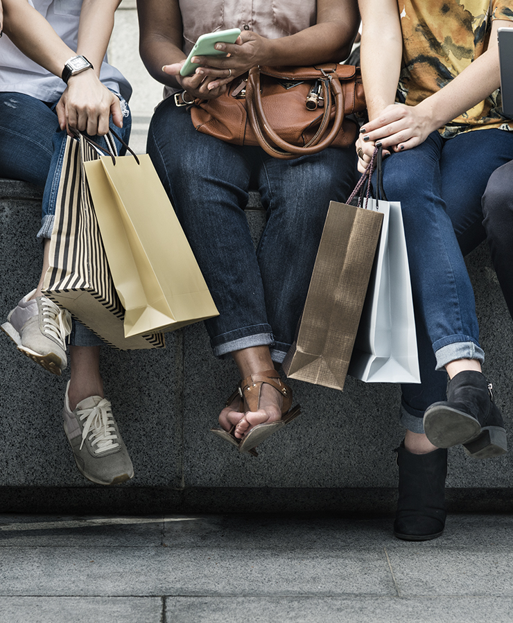 Women sitting with shopping bags
