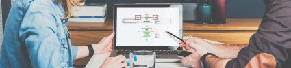 Two people looking at computer screen analyzing Google data flow
