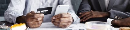 Man holding credit card and phone