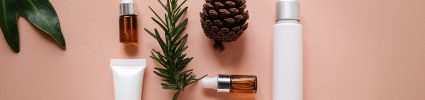 Natural beauty product on pastel background with leaves and pine cone