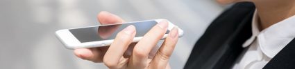 Person using voice assistant by talking into phone