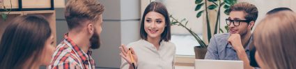 Two employees smiling and talking