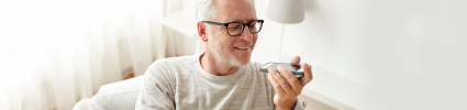 Senior aged man using his phone
