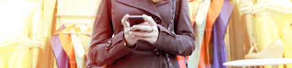 woman in coat holding phone