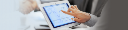 close up of hand pointing at analytics on iPad screen