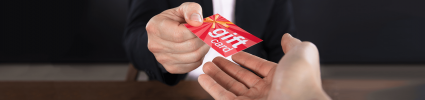 Handing a gift card to merchant