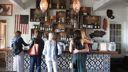 Group of attendees standing in front of bar