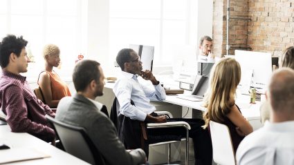 Group of digital marketers listening to a speaker