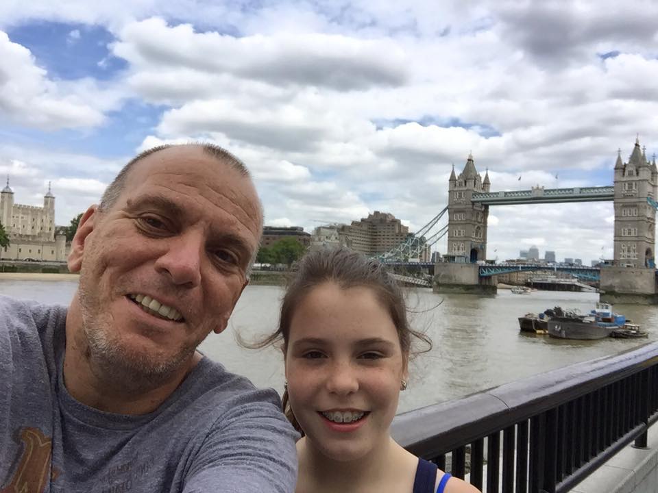 Peter Petrou standing next to London Bridge