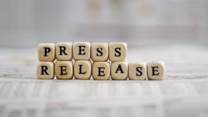 Wood blacks stacked to spell "Press Release"