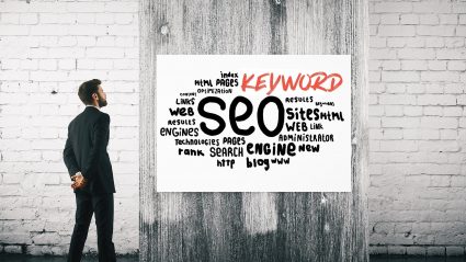 Man looking at wall with words SEO Keyword