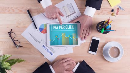 Table top with tablet screen showing pay per click