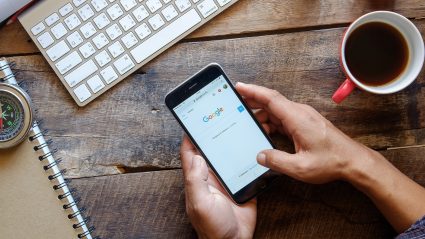 wood desk holding a phone google paid search