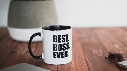 Mug sitting on desk which says "Best Boss Ever"