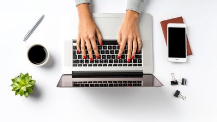 Woman marketer typing on laptop