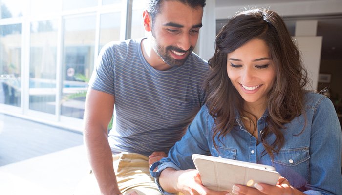 man and woman looking at tablet