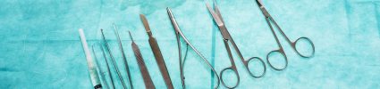 doctors tools laid out on teal background