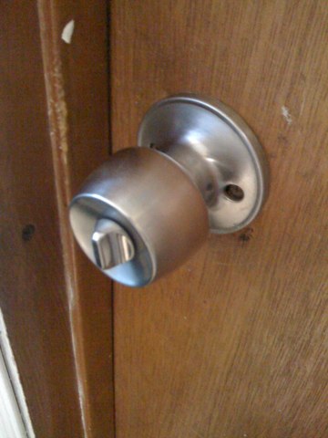 Standard silver doorknob on wood door