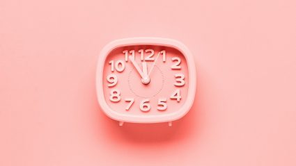 pink retro alarm clock on pink background