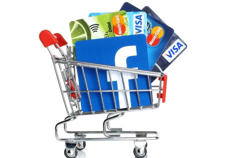 shopping cart with credit cards and facebook logo inside