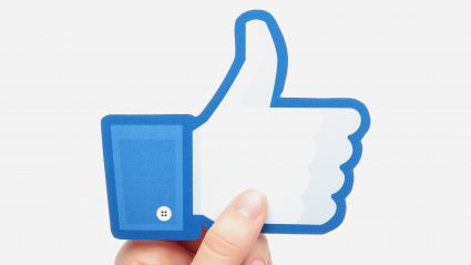 facebook like icon held by persons hand
