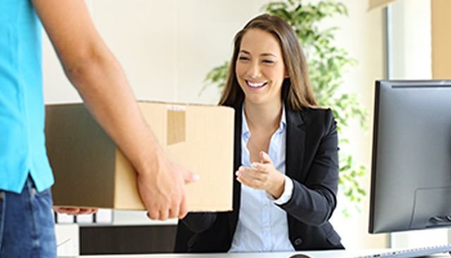 Woman receiving a package at work