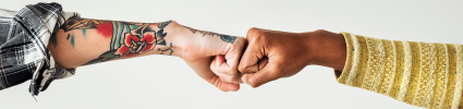 Two fists coming together to show connecting cultures