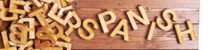 wood letters on a wood surface spelling out Spanish