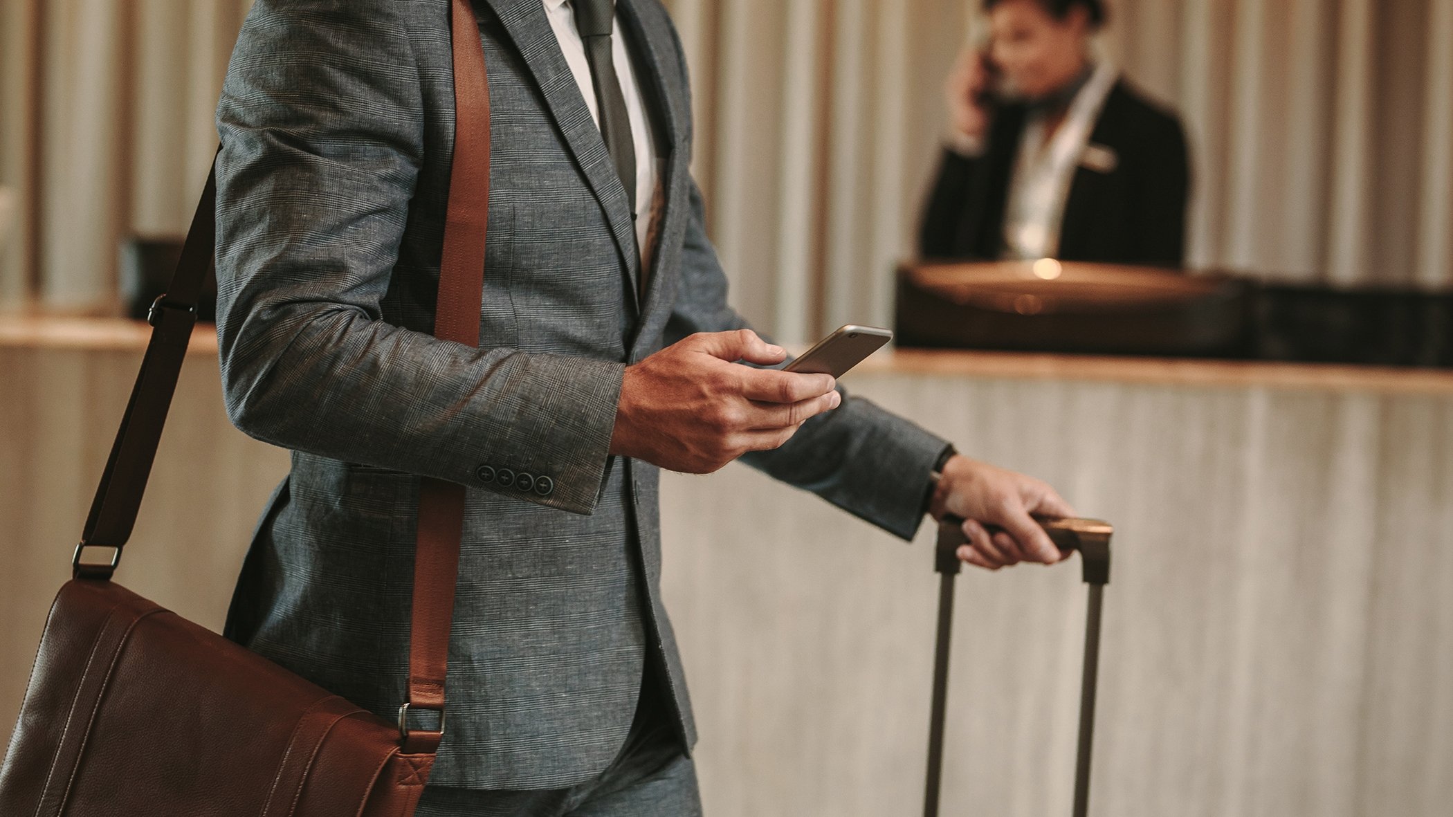 man holding phone at hotel