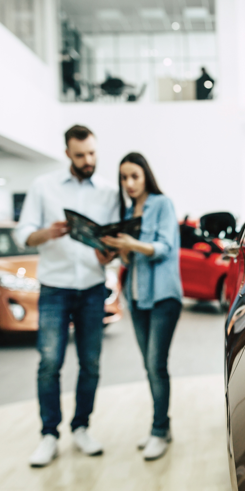 couple buying car in dealership