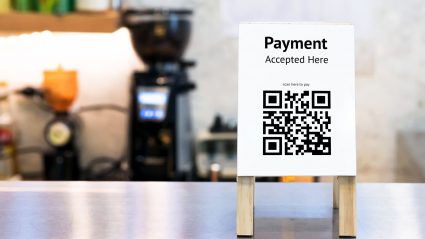 qr code sign at coffee shop counter reads payment accepted here