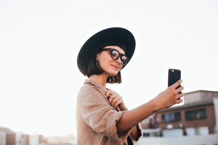 micro influencer girl taking video of herself on phone