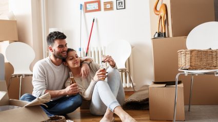 Couple sitting on floor uppacking