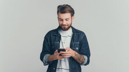 young handsome man watching video on his phone