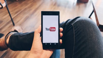 holding mobile phone youtube marketing logo