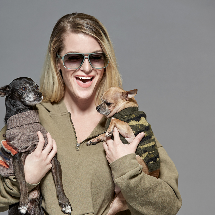 Wpromoter wearing Zenni glasses holding two dogs
