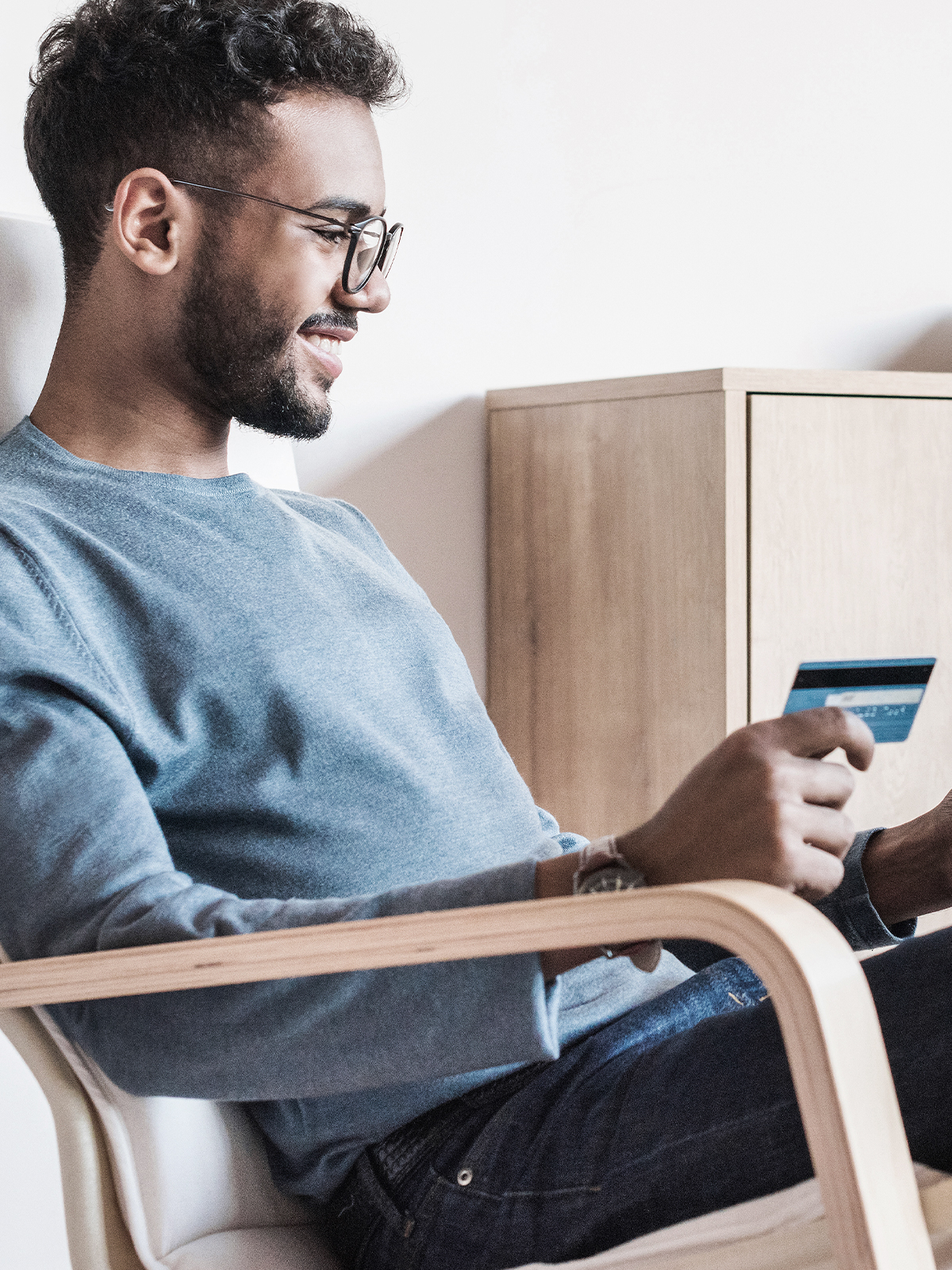 Man sitting holding credit card