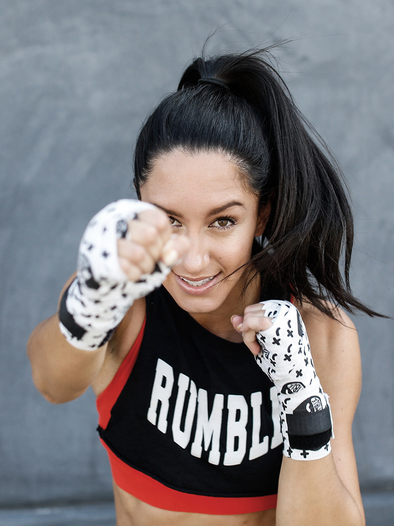 Woman with Rumble boxing shirt and gloves