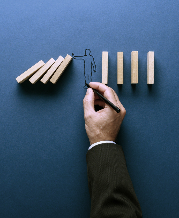 drawing of man stopping falling dominoes