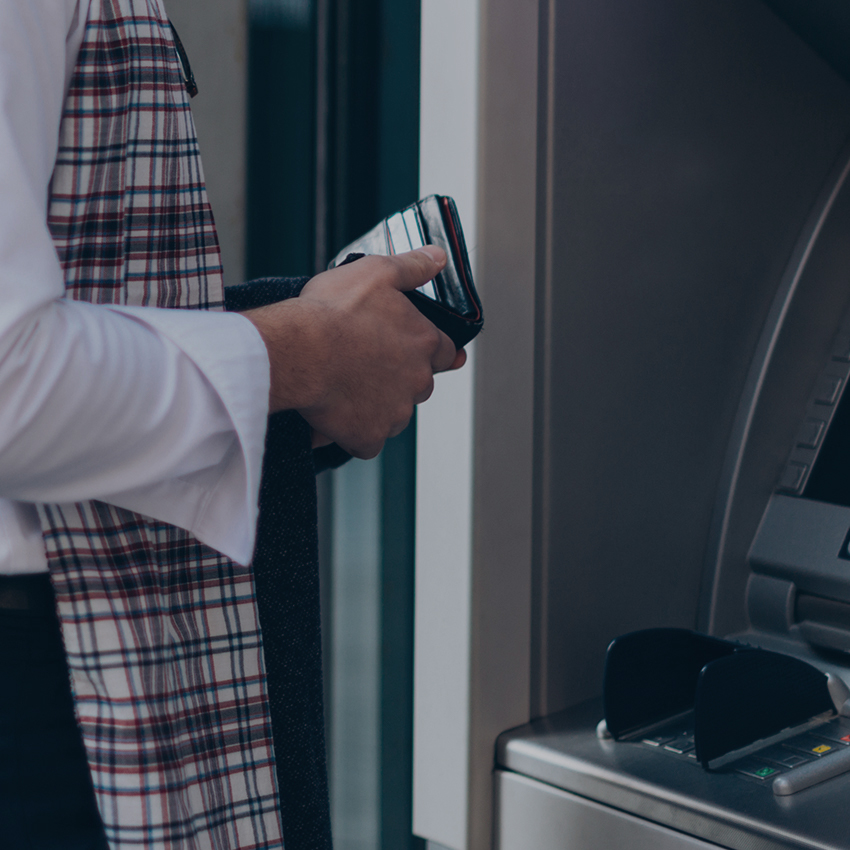 man with wallet at atm
