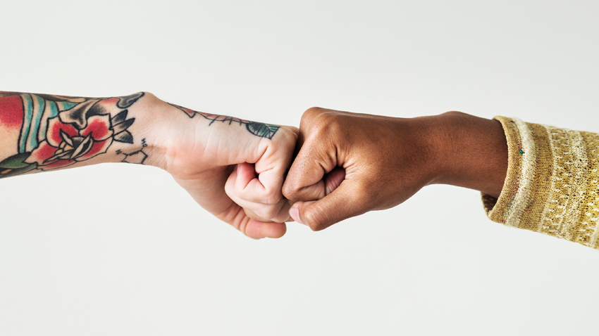 two hands fist bumping