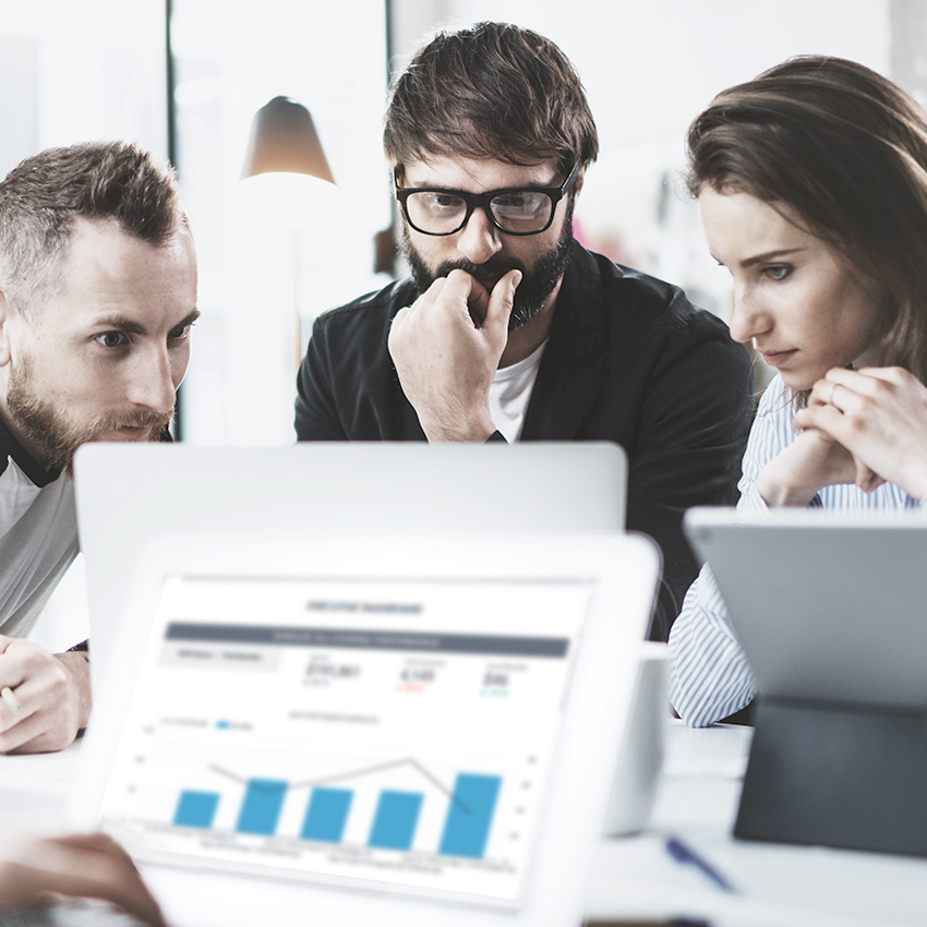 Business team looking at computer screens