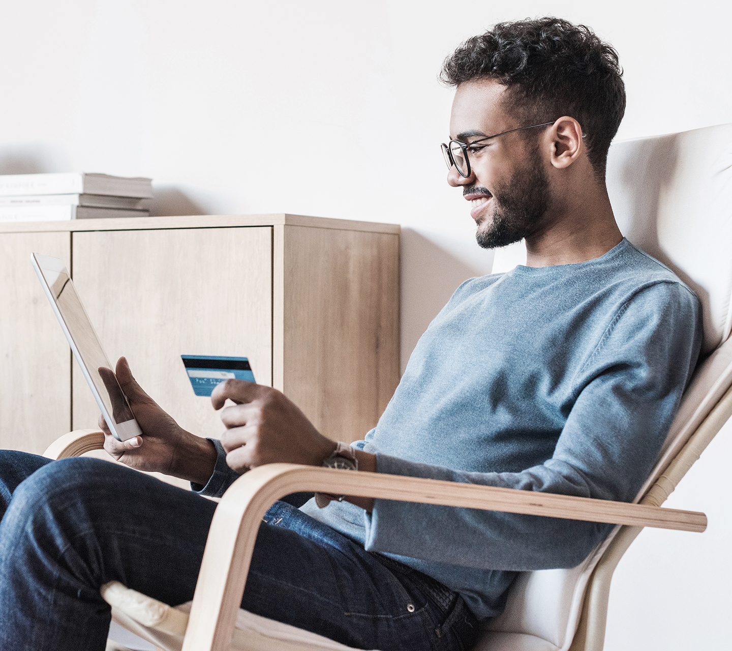 Man sitting holding credit card