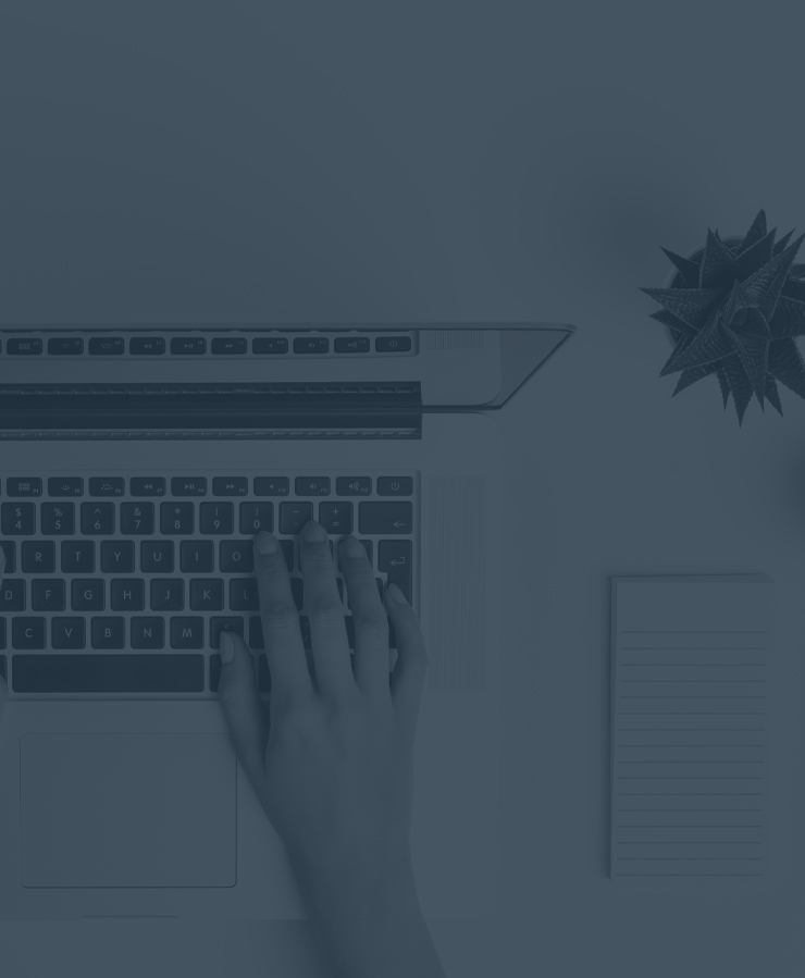 hands typing on laptop blue overlay