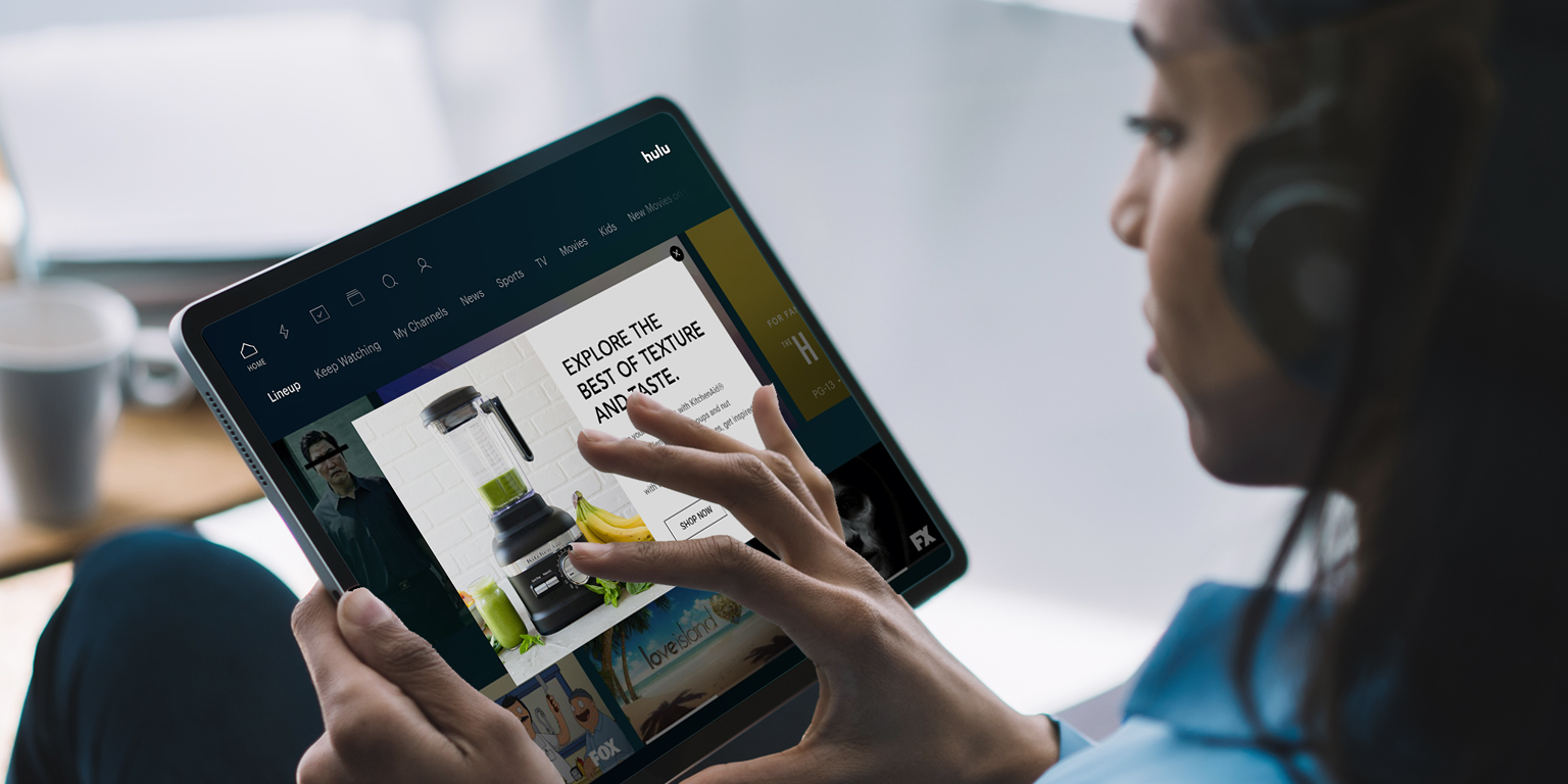 woman watching Hulu on tablet
