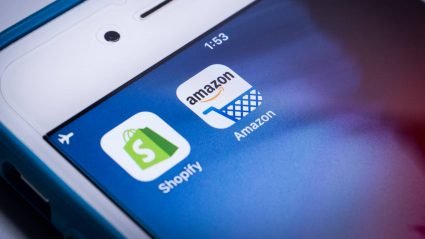 Mobile phone displaying Shopify and Amazon apps