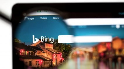 A magnifying glass on Bing's website, displayed on a laptop computer
