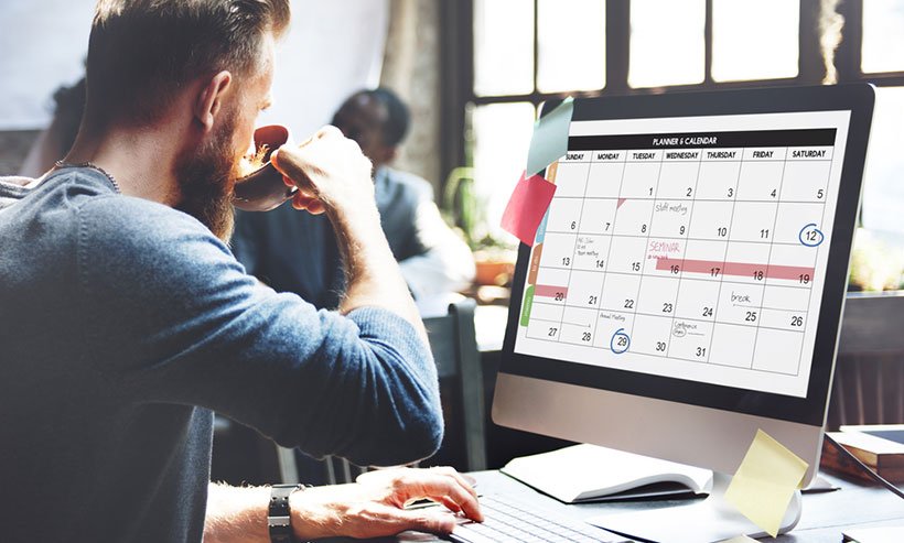 man-reviewing-calendar-on-computer