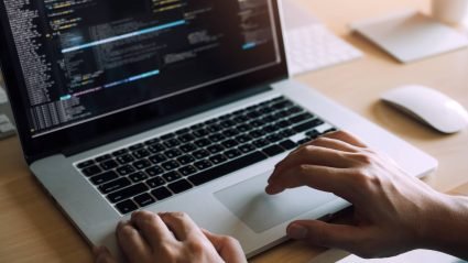 Person editing code on a laptop